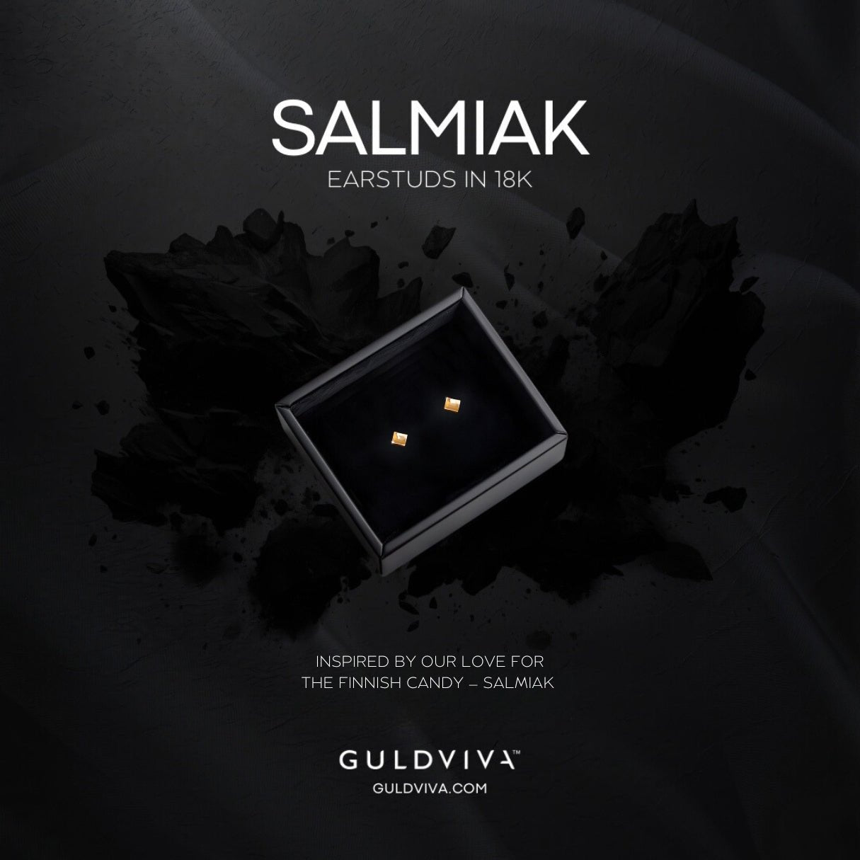 Two square 18K gold stud earrings presented in a black box on a dark background.