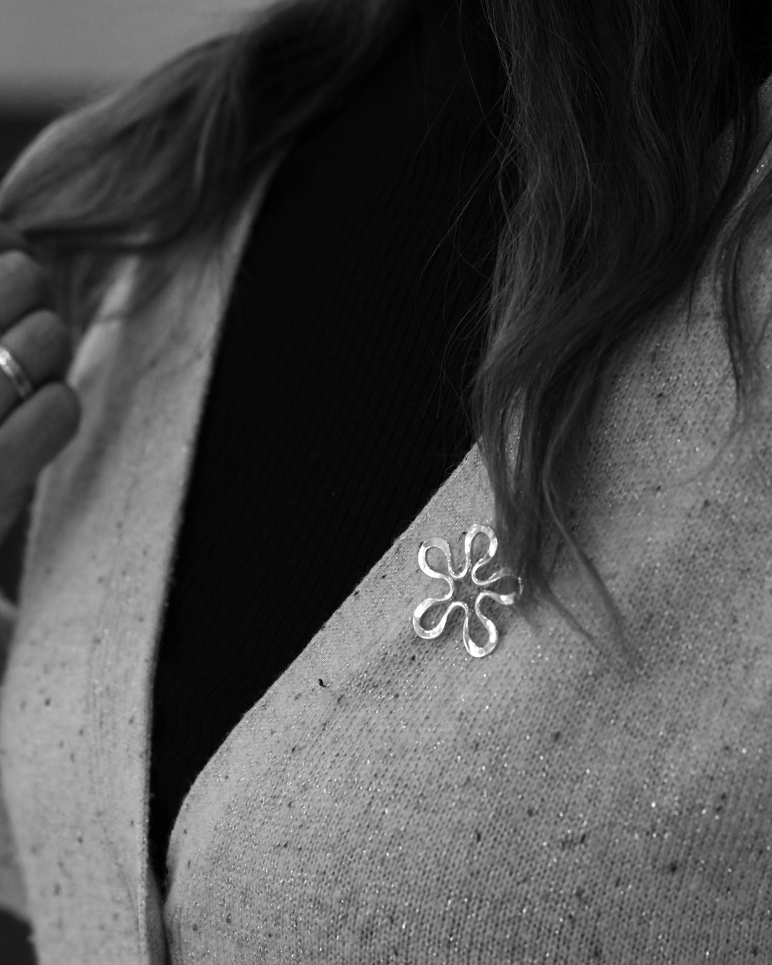 BLOMMAN L brooch in sterling silver shown on the shoulder from a different angle