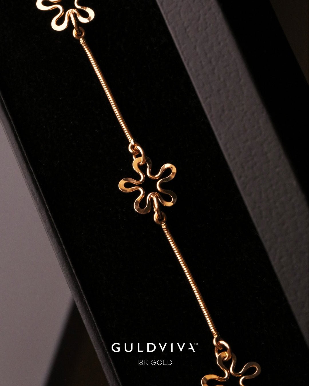 BLOMMAN Duo 18K gold armband with a flower shaped charm along a slim chain