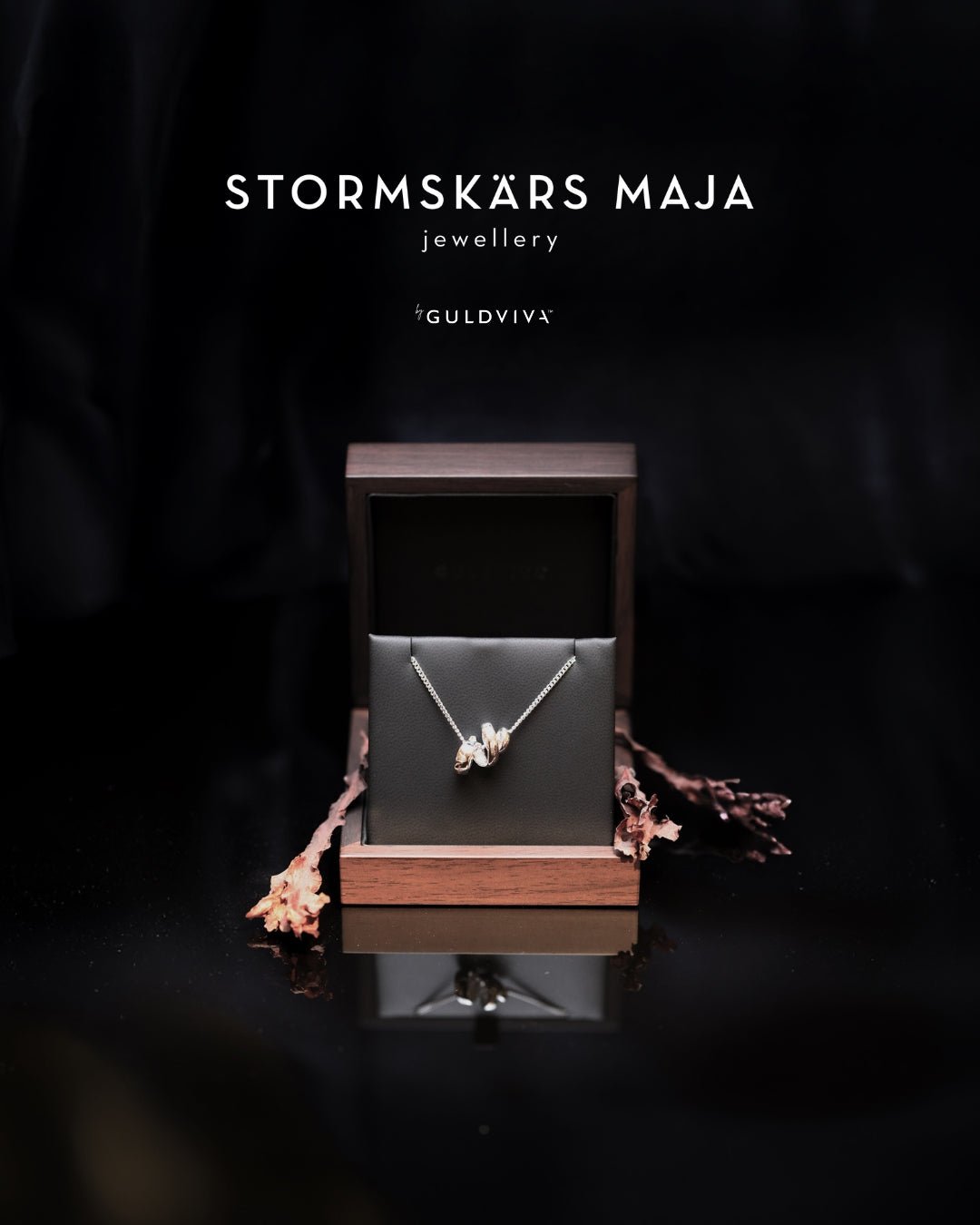 Stormskärs Maja bold silver necklace with an oversized abstract pendant displayed in a wooden box.