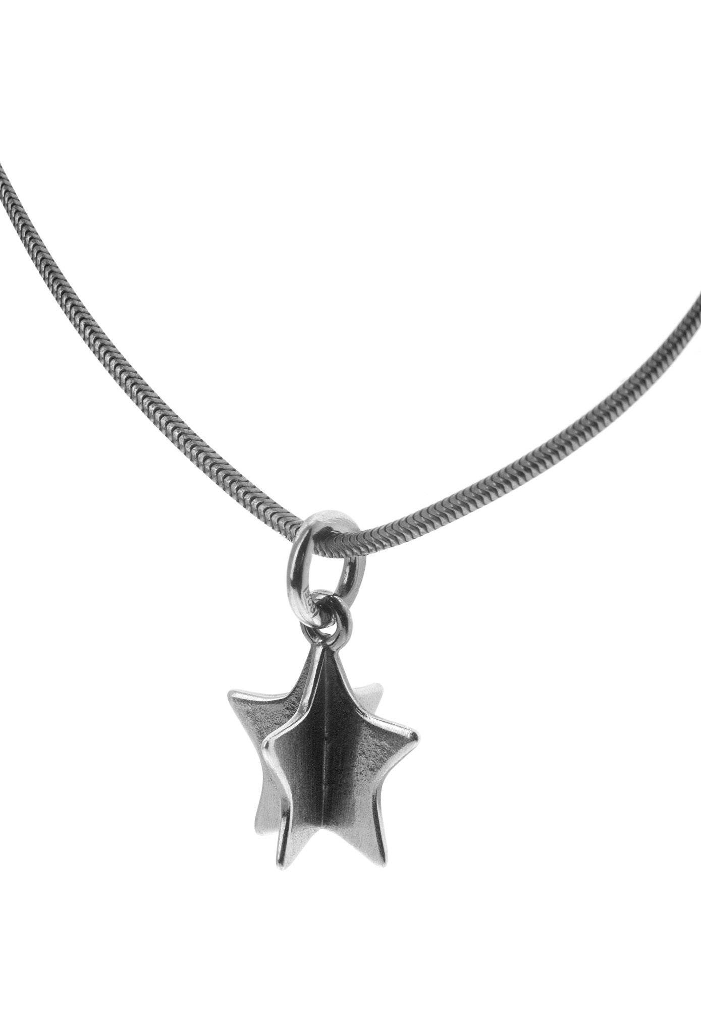 Silver necklace featuring a star shaped pendant on a slender chain