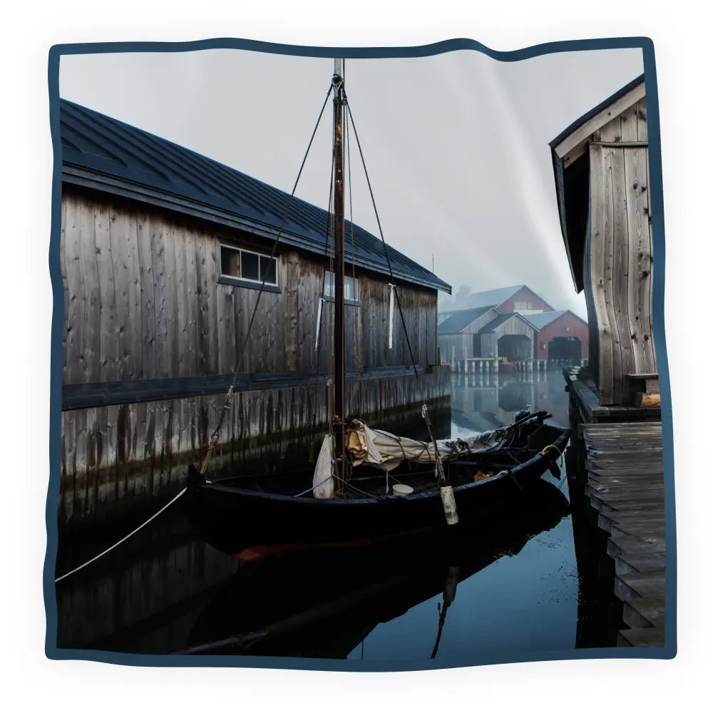 HEMMA HAMN silk scarf motif showing a harbor with a boat beside wooden buildings