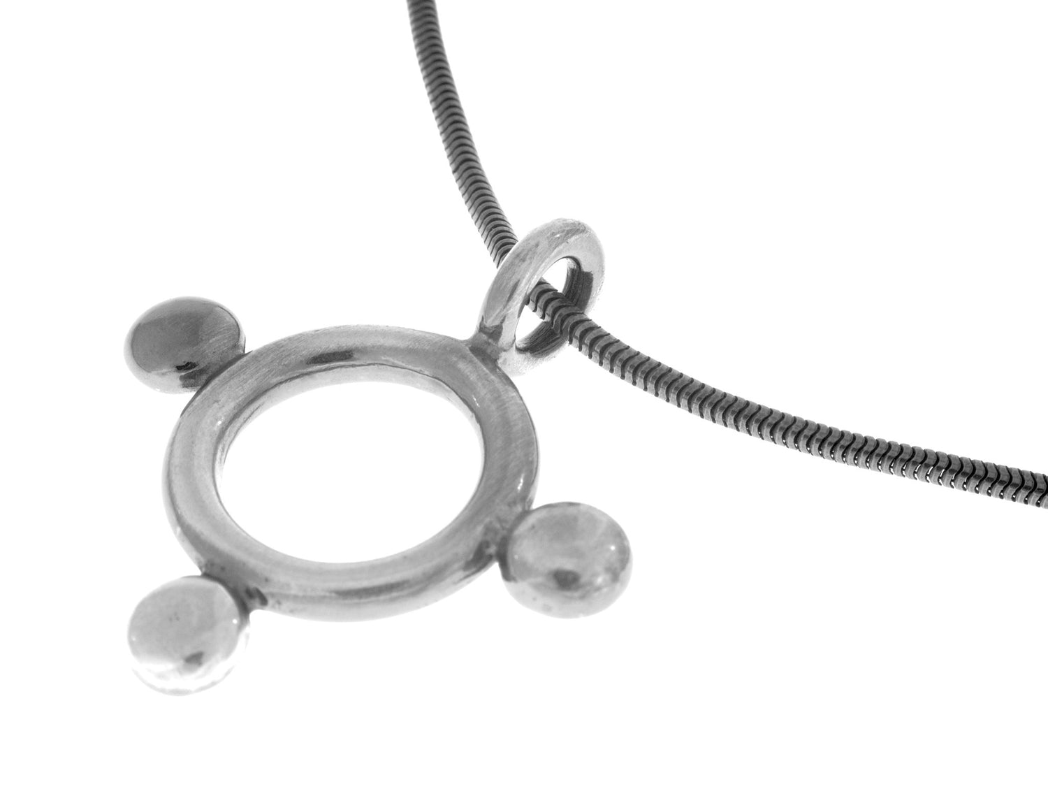 Close up of SIGN L necklace showing an antique finish metal ring and ridged chain.