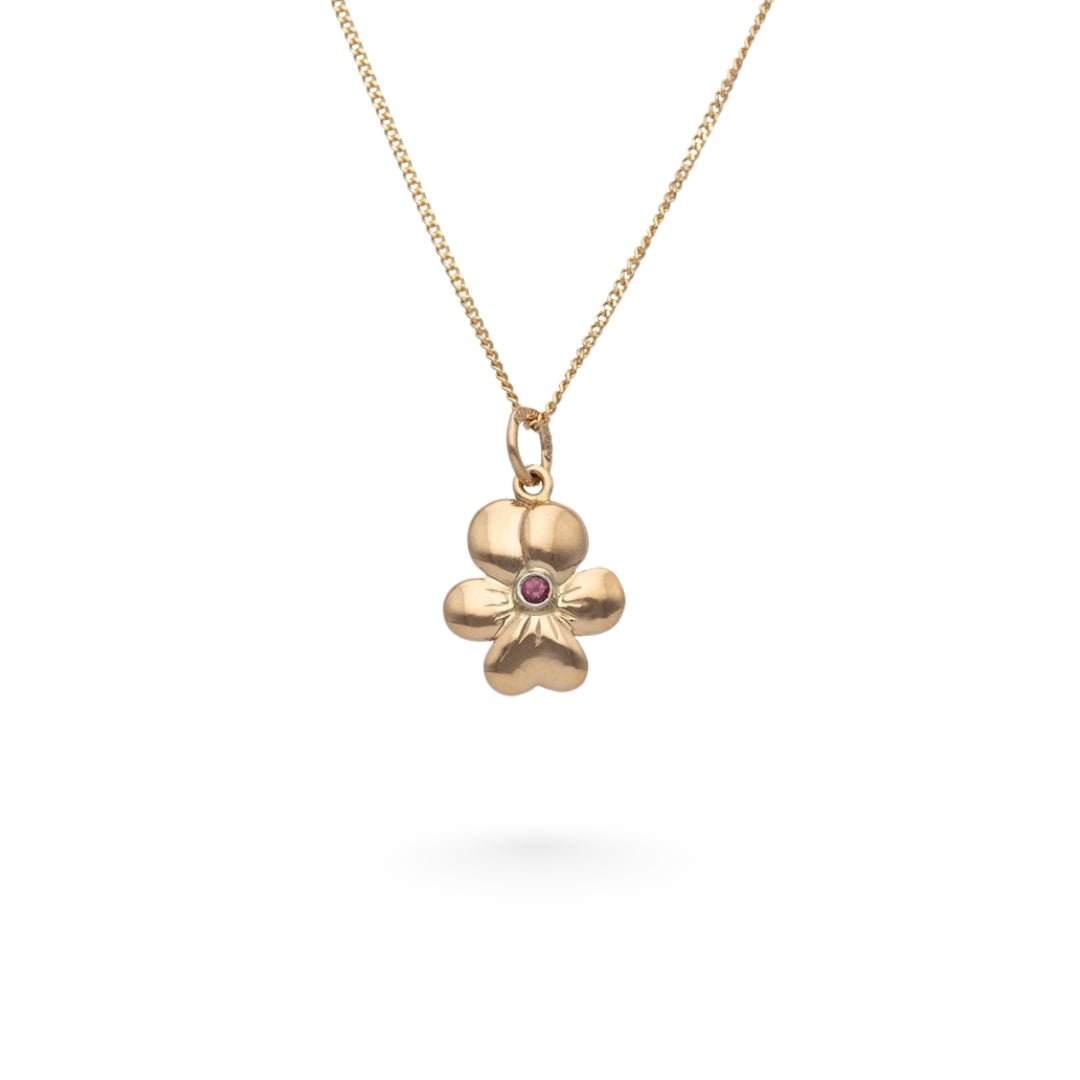 18K guld halsband med violformad blom och granat i mitten