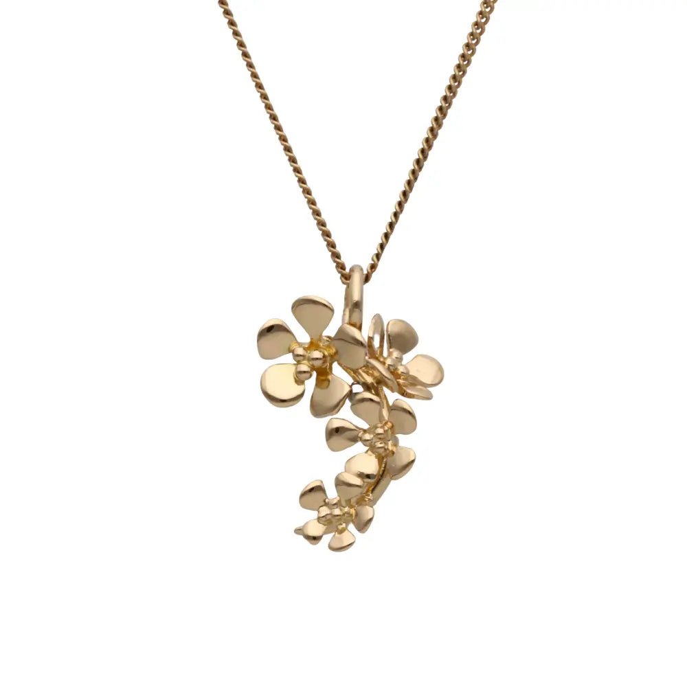 18K gold flower cluster pendant on a delicate chain worn at the neck