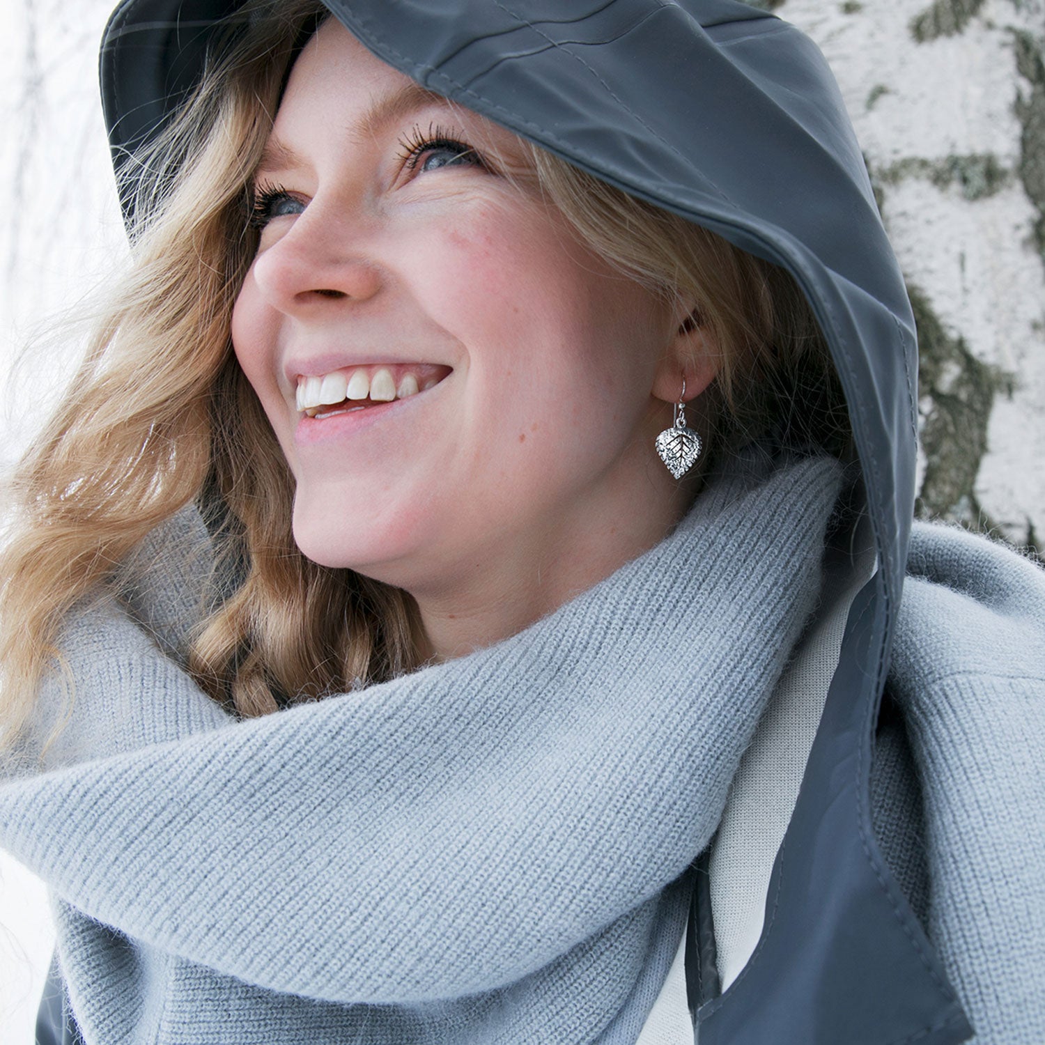Woman wearing leaf shaped 925 sterling silver earrings on hooks from BJÖRK