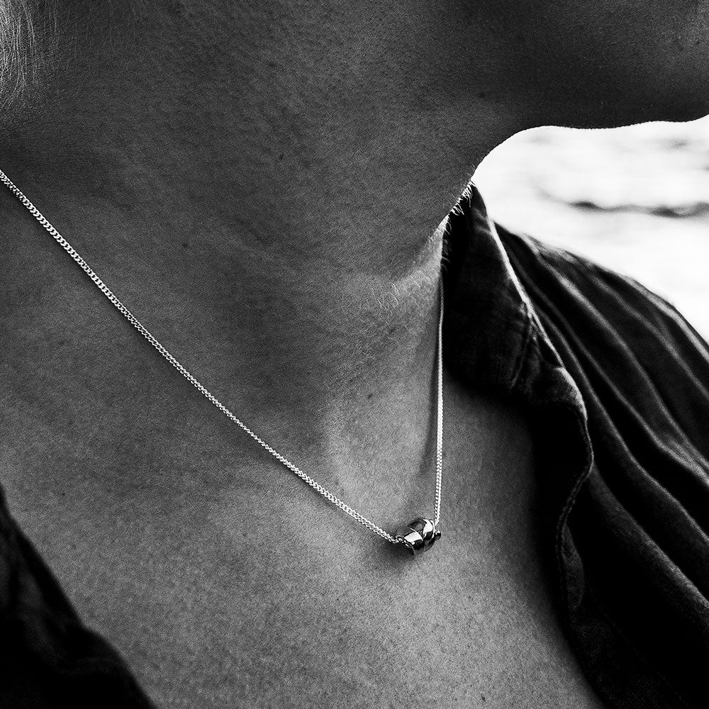 Close-up of a neck wearing STORMSKÄRS MAJA S silver pendant necklace.