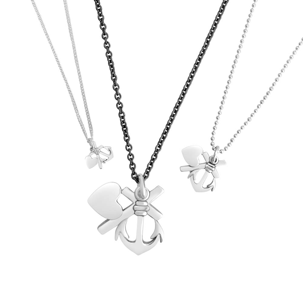 Three silver Tro hopp och kärlek XS necklaces with heart and anchor charms on different chain styles.