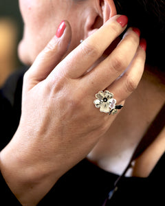 Close up of a hand wearing a GULLVIVA silver flower ring on the finger