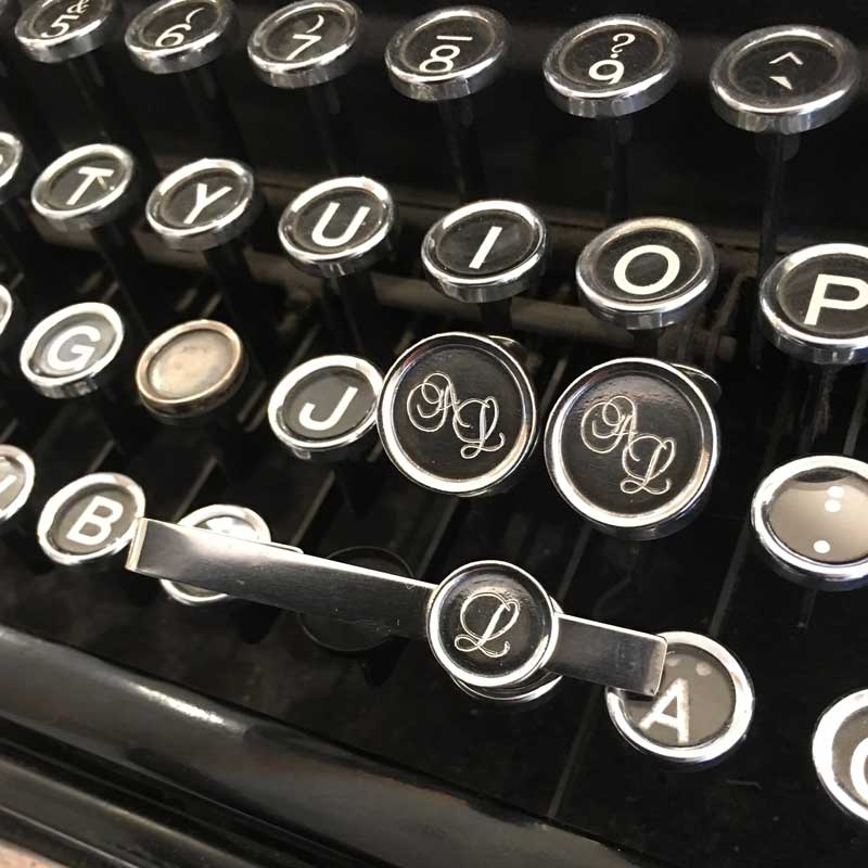 ALFA cufflink with round monogram faces on dark center, crafted in 925 sterling silver with antique finish.