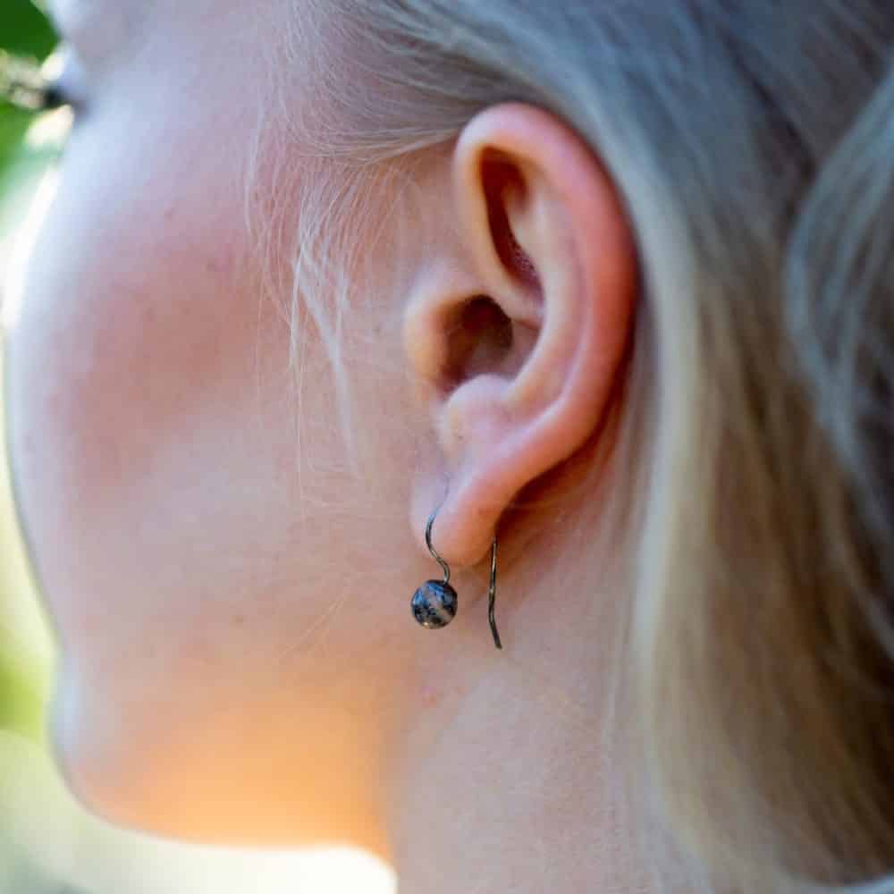 Öra med STRAND örhängen i sterling silver med små strandstenar hängande från krok
