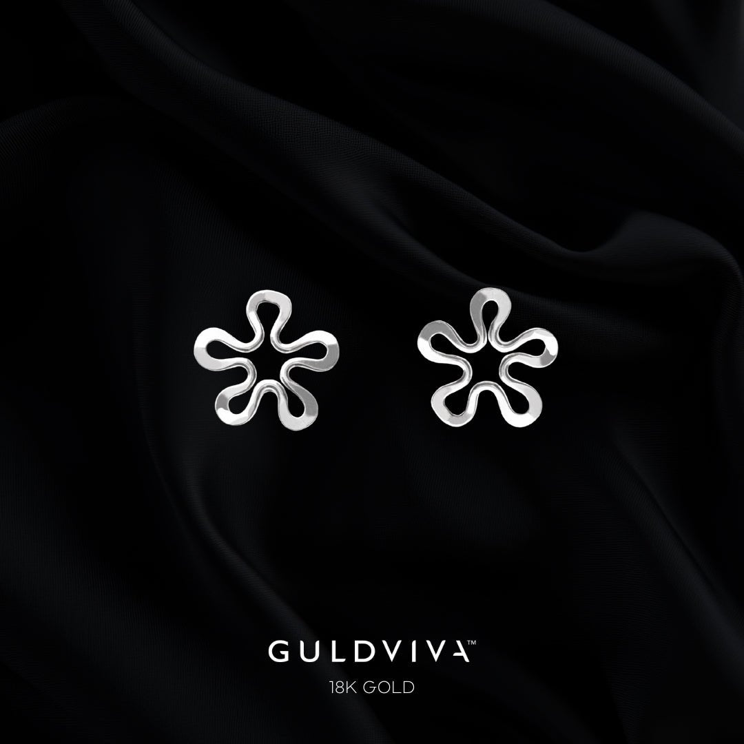 Blomman 18K white gold flower stud earrings on black satin