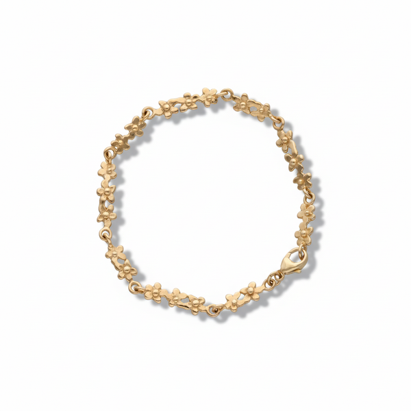 18K guld armband med små blomformade länkar längs hela kedjan 18,5 cm