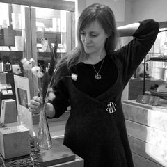 KRINGLAN XL brooch worn on a dark wrap dress with hammered silver curves