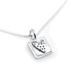 Square silver pendant with a perforated heart design on a delicate chain necklace