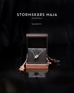 Stormskärs Maja bold silver necklace with an oversized abstract pendant displayed in a wooden box.