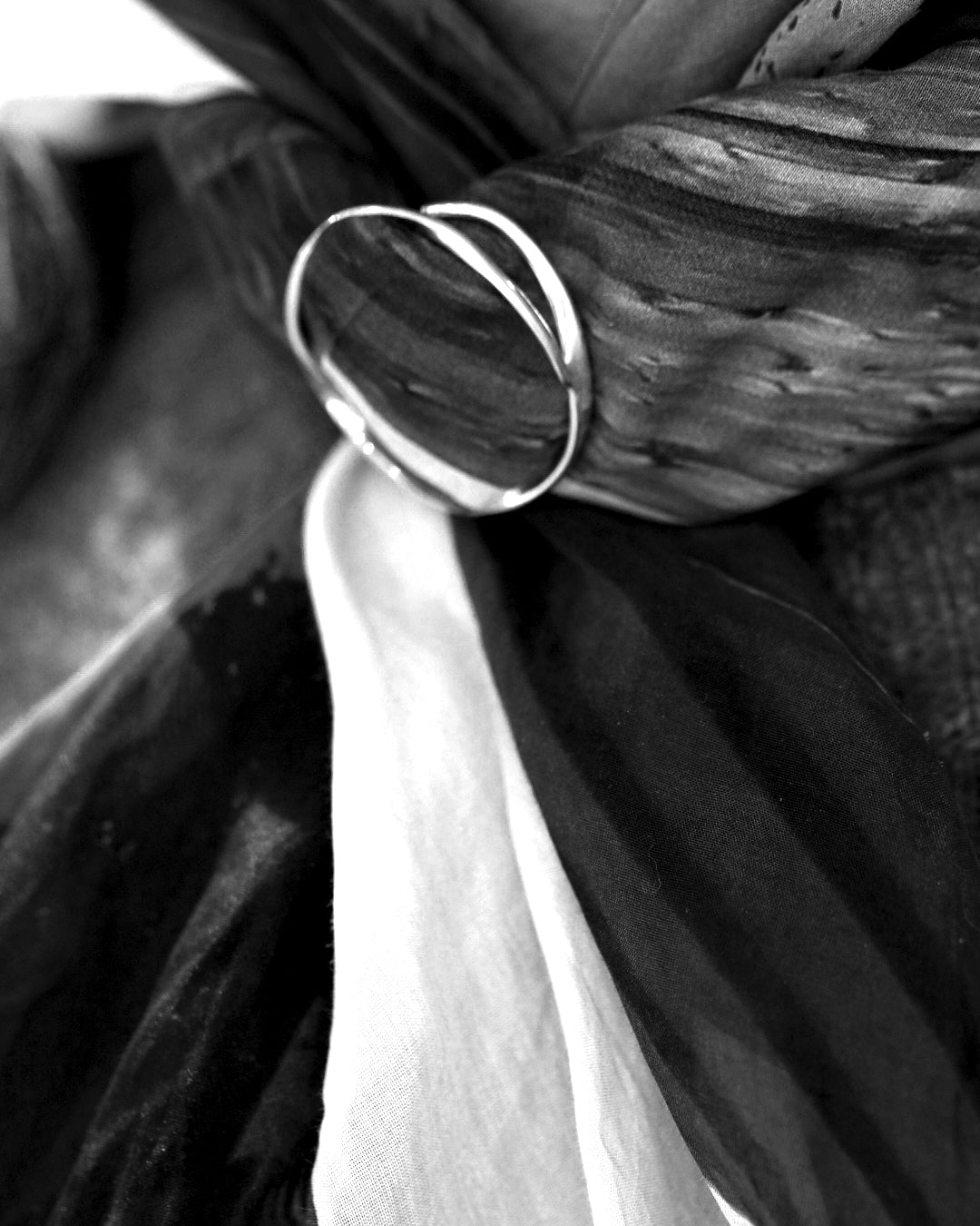 Maja S Scarfring in sterling silver featuring two interlocking rings resting on scarf