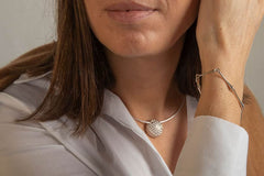 Peggy armband in sterling silver worn on a woman's wrist with peg inspired geometric links