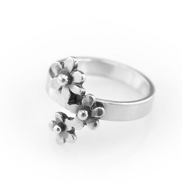 Sterling silver ring with three forget-me-not flowers on a smooth band