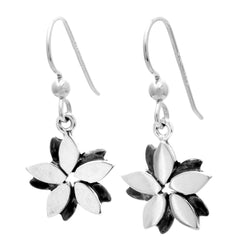 Flower shaped earrings on hook wires with six petals in light and dark antique finishes