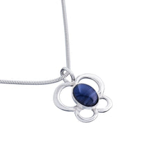 Silver flower shaped pendant with a blue oval spectrolite stone on a slim chain