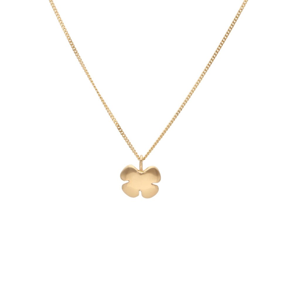 Close up of KLÖVER 18K gold flower pendant necklace on a delicate chain.