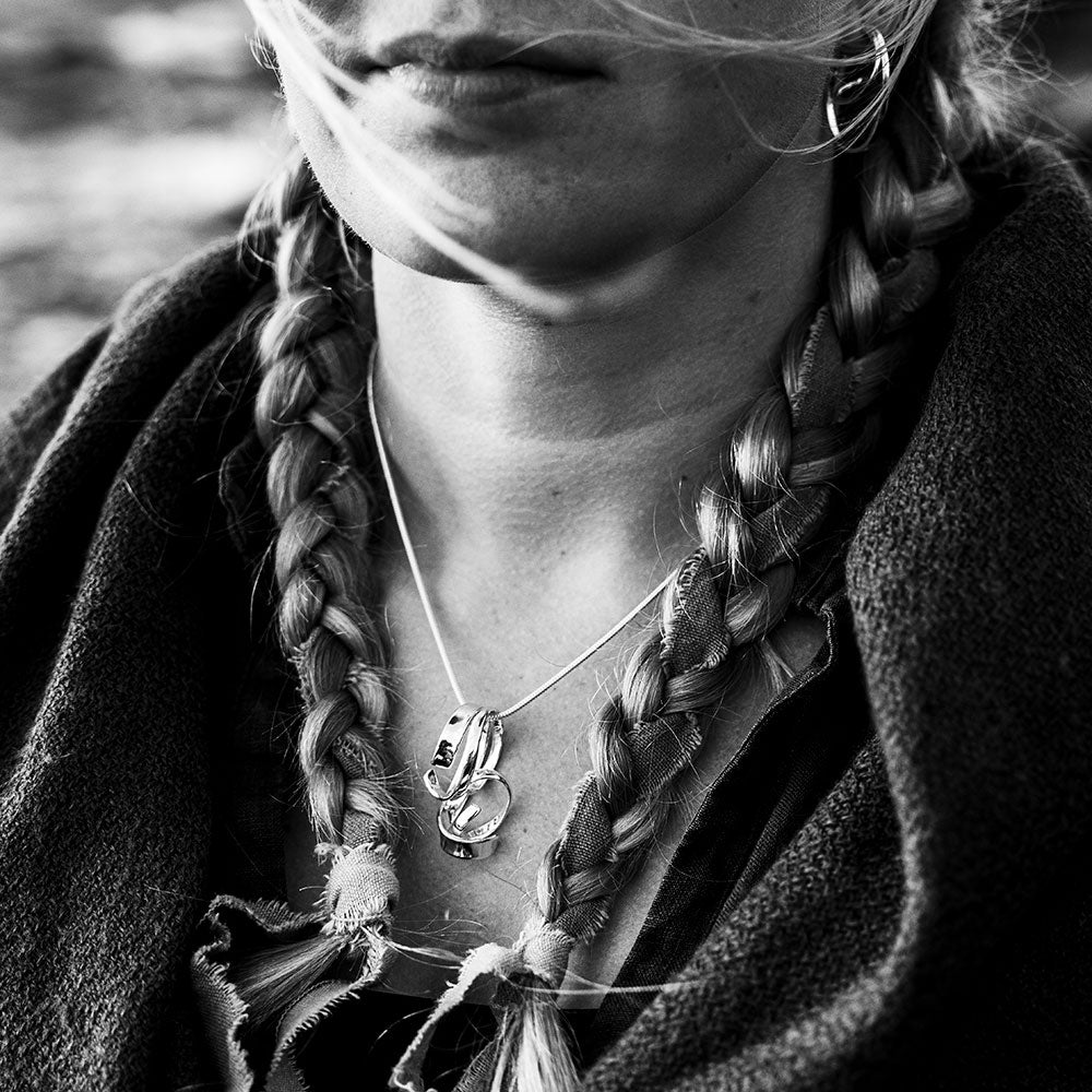 Close-up of the STORMSKÄRS MAJA FEST pendant necklace in polished sterling silver worn on the neck