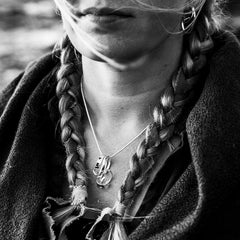 Close-up of the STORMSKÄRS MAJA FEST pendant necklace in polished sterling silver worn on the neck