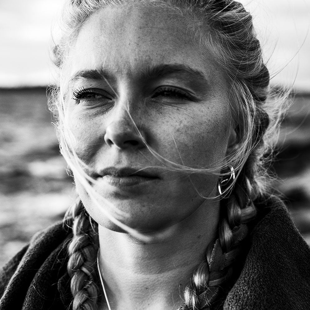 Close-up of a woman wearing STORMSKÄRS MAJA FEST sterling silver stud earrings