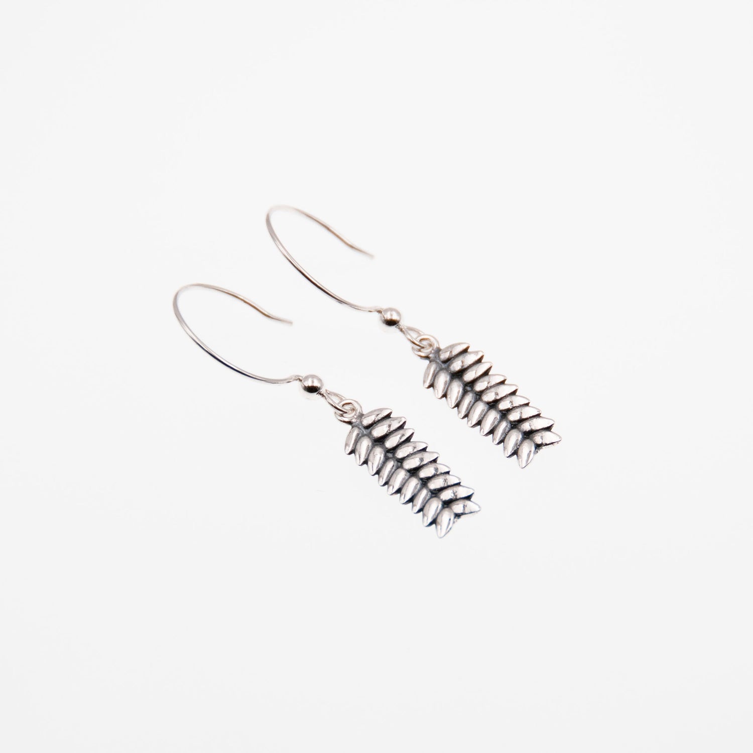 RÅG earrings on hooks with chain detail photographed against a pale background.