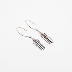 RÅG earrings on hooks with chain detail photographed against a pale background.