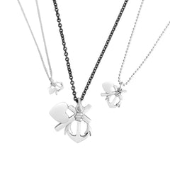 Three silver Tro hopp och kärlek XS necklaces with heart and anchor charms on different chain styles.
