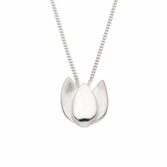Close up of a silver Tulpan Nova tulip pendant on a delicate chain.