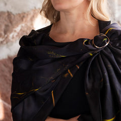 Model wearing UNDER YTAN scarf in dark navy with subtle yellow streaks draped over the shoulder
